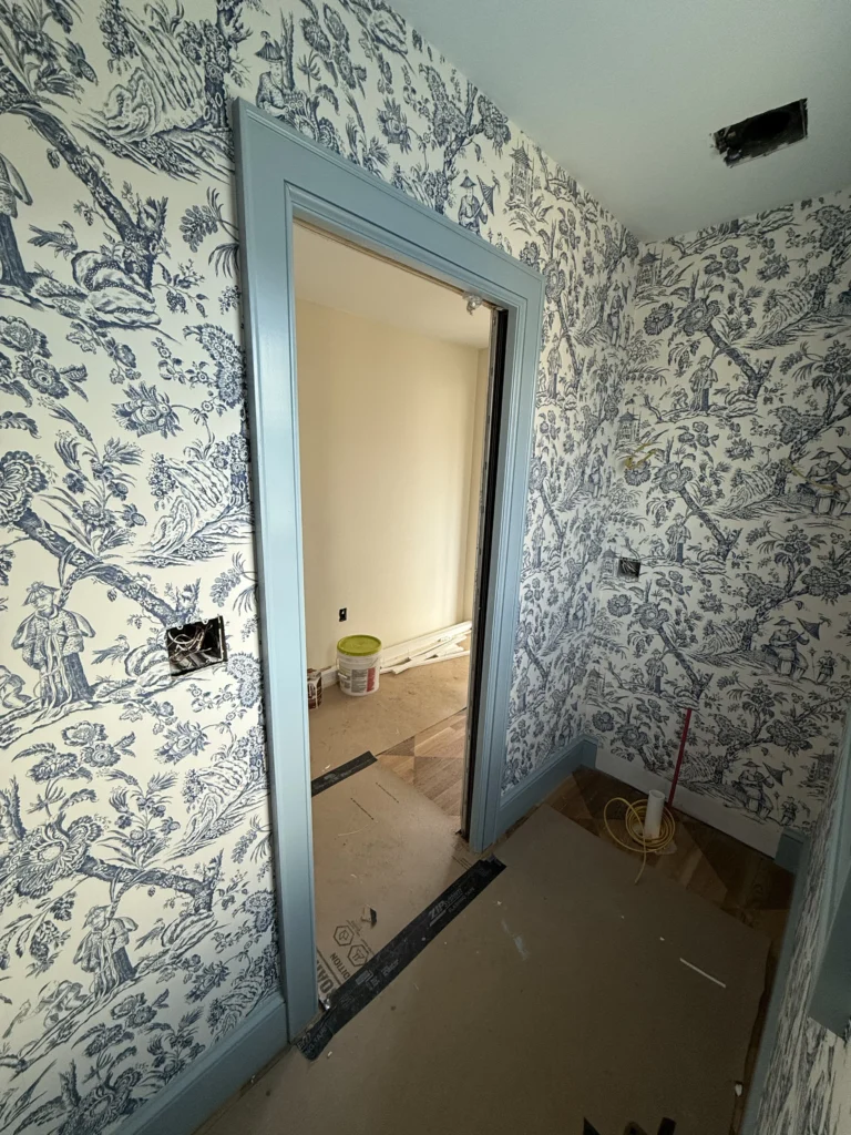 Custom wallpaper and painted trim installation in a Bristol, VA powder room