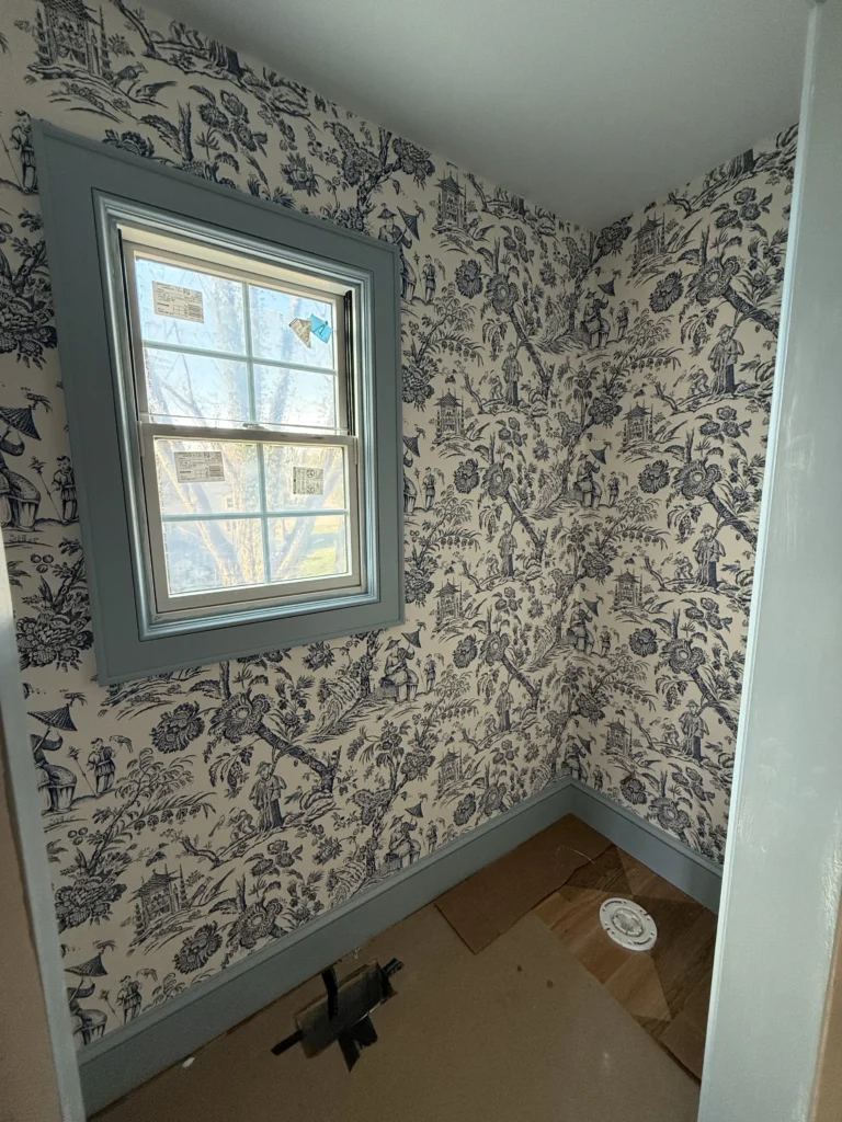Decorative wallpaper with custom painted window trim in a Bristol, VA powder room