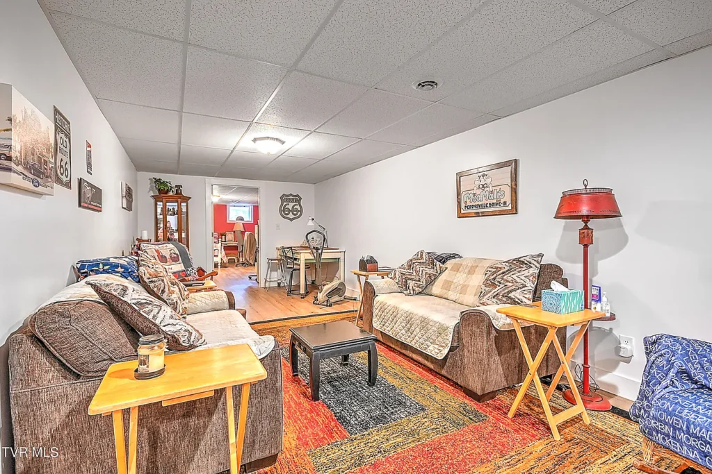 Basement lounge area with shelving and seating in Afton remodel