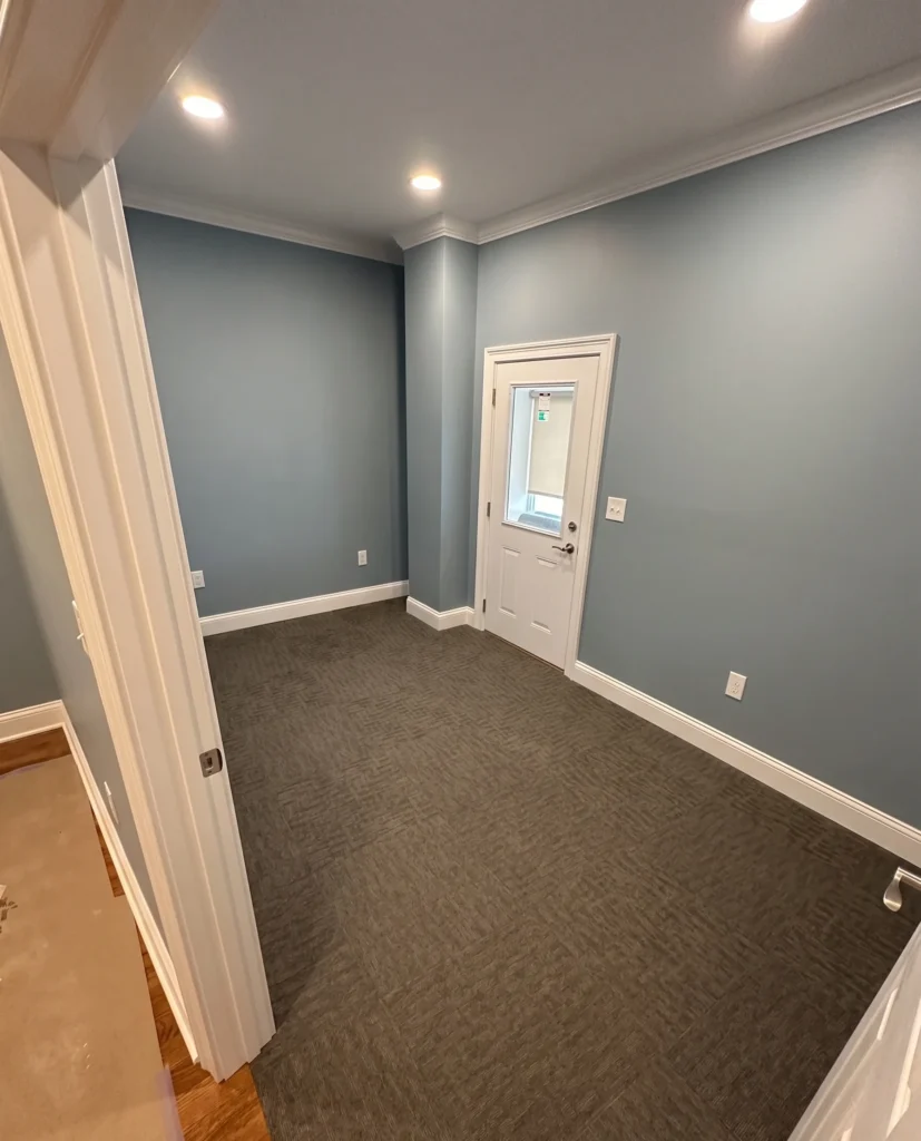 Completed glue-down carpet tile flooring in Bristol TN commercial office with blue accent walls