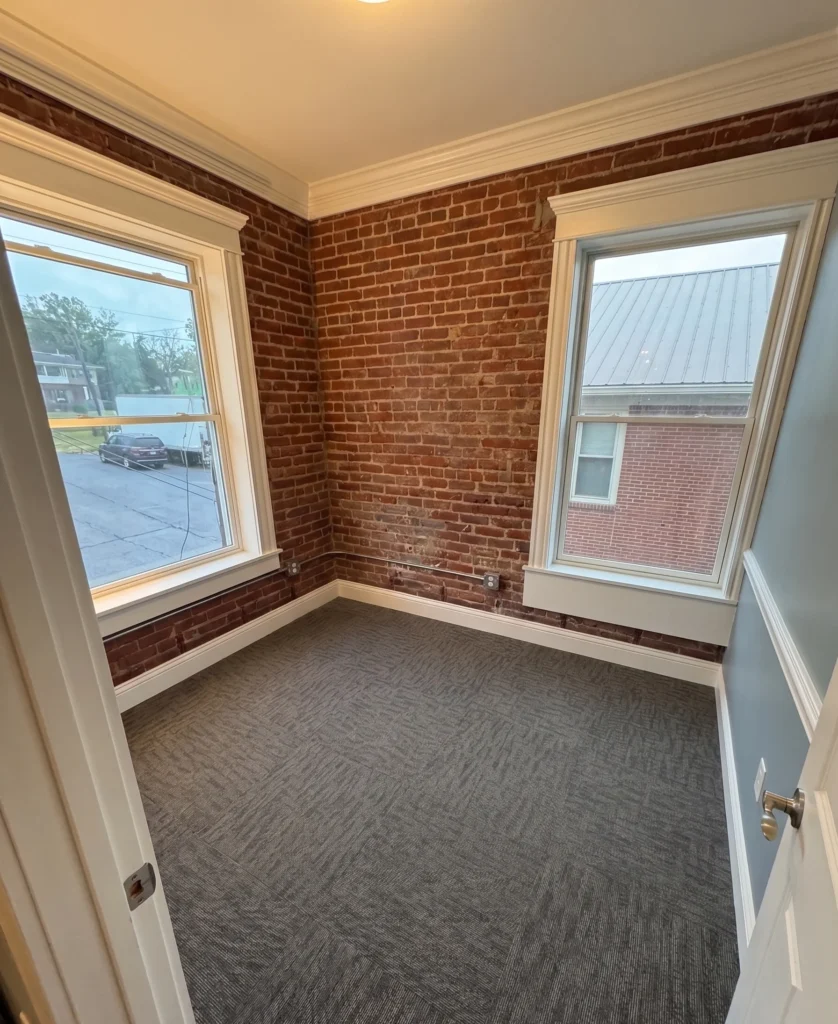 Glue-down carpet tile flooring installed in historic Bristol TN office with exposed brick walls