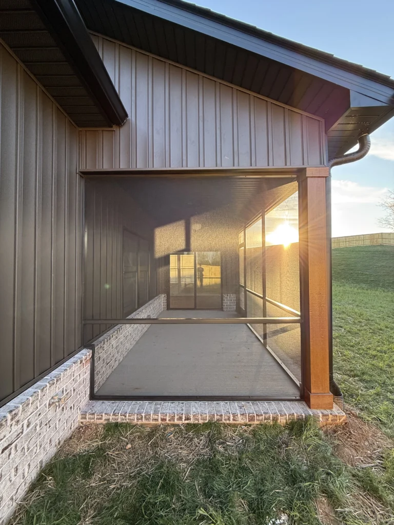 Screened-in porch installation on a new construction home in Gray, TN at sunset