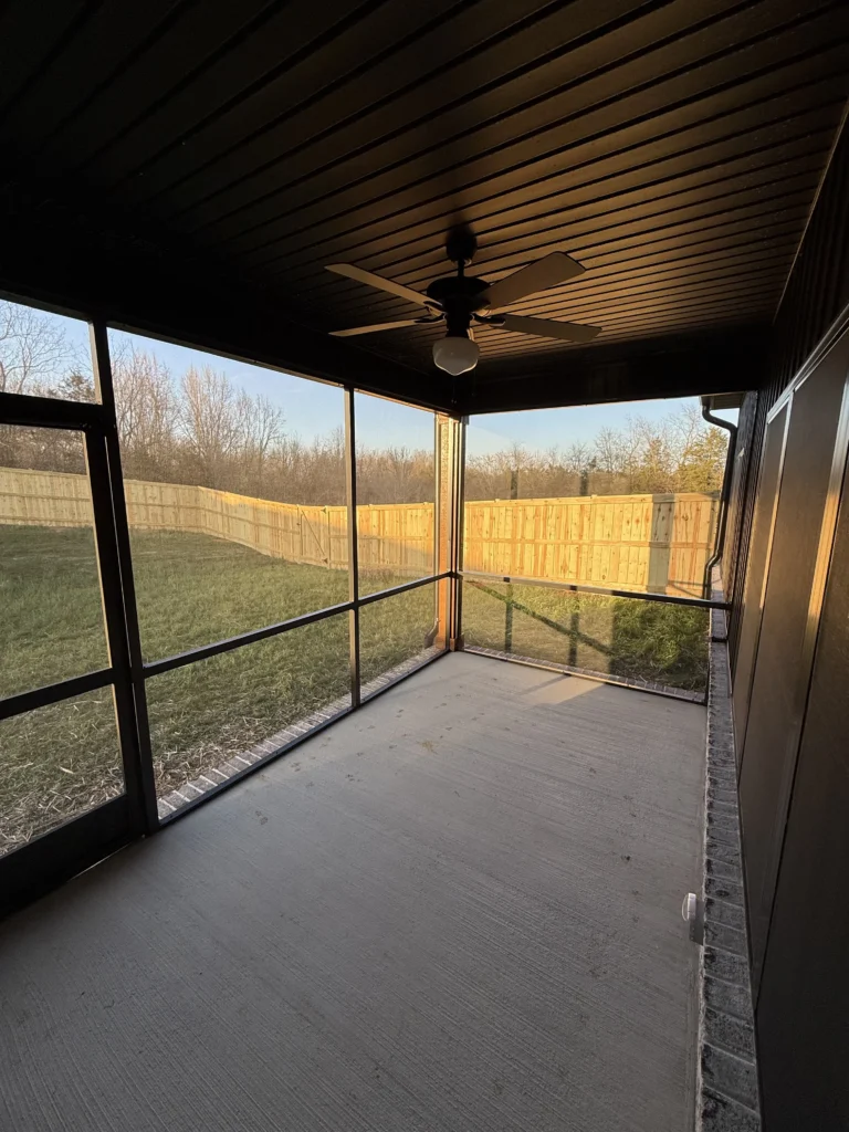 Finished screened porch with ceiling fan and panoramic backyard views in Gray, TN