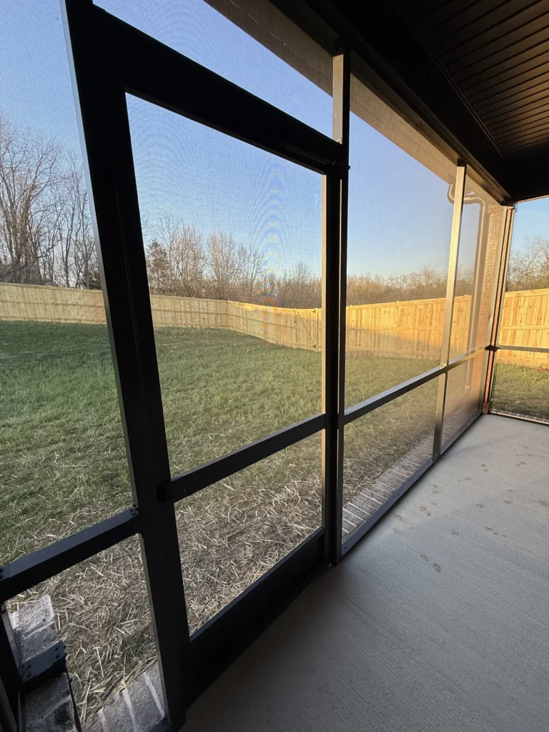 Completed screened porch installation with modern black framing on a new construction home in Gray, TN