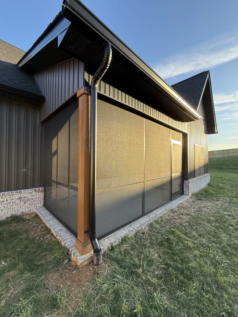 Completed screened porch installation with modern black framing on a new construction home in Gray, TN