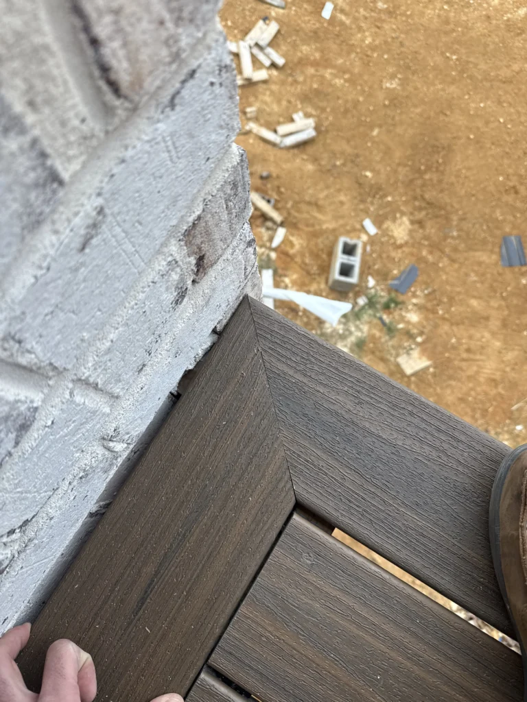 Close-up of precision mitered Trex picture-frame border detail on a new construction deck in Gray, TN