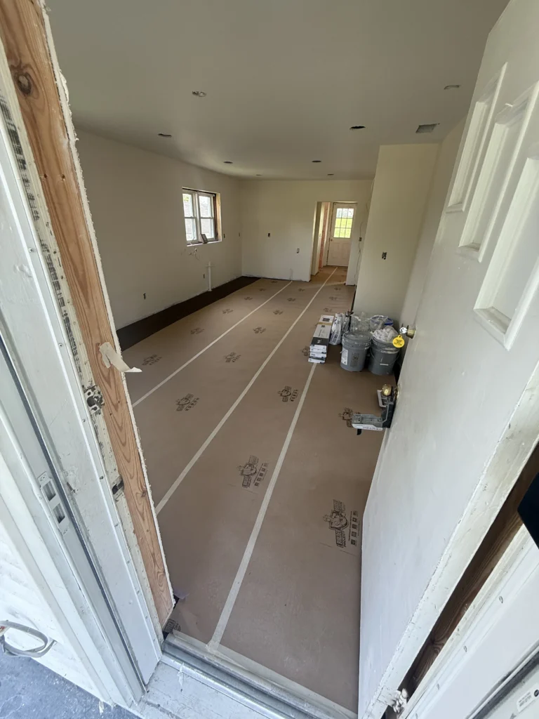 Floor protection and materials prepared during LVP flooring installation in Johnson City, TN