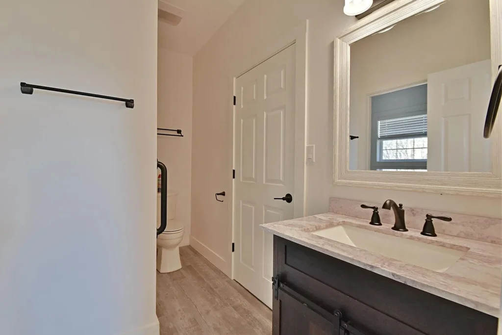 Modern guest bathroom with a custom vanity and luxury vinyl flooring