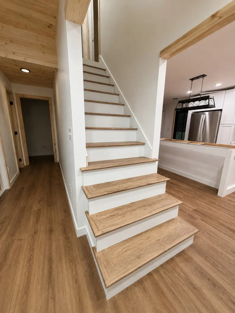 Completed staircase flowing into kitchen in Piney Flats home remodel