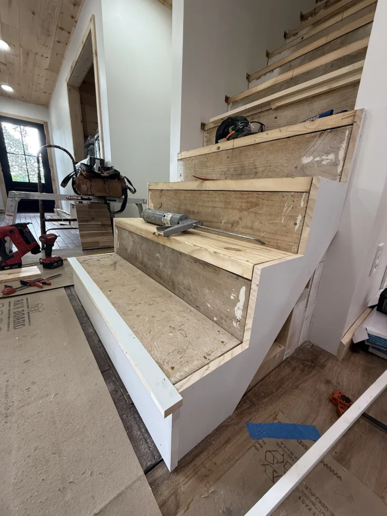 Unfinished plywood stair treads during Piney Flats staircase remodel