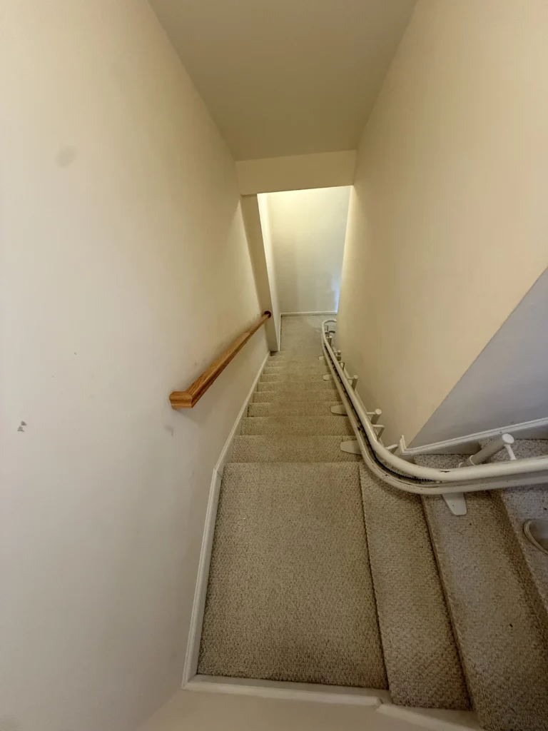 Carpeted staircase before hardwood flooring installation in Kingsport, TN