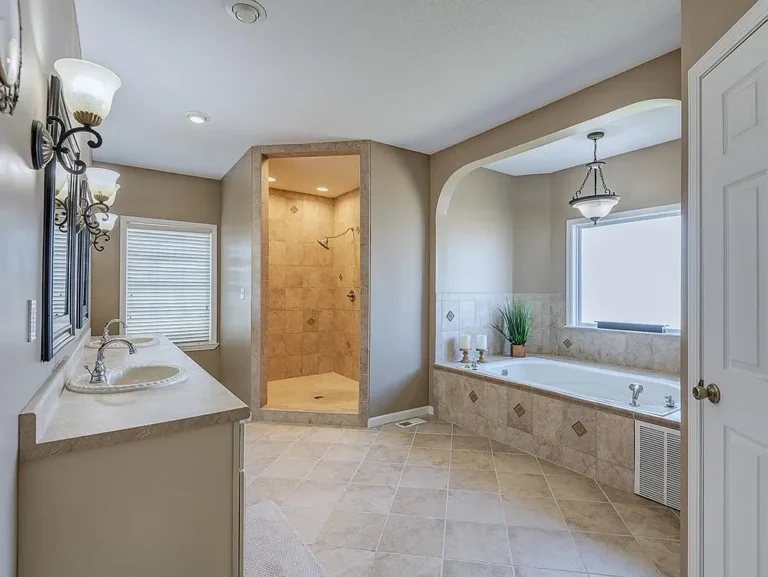 Spacious master bathroom with double vanity, walk-in tile shower, and soaking tub in Strawberry Plains